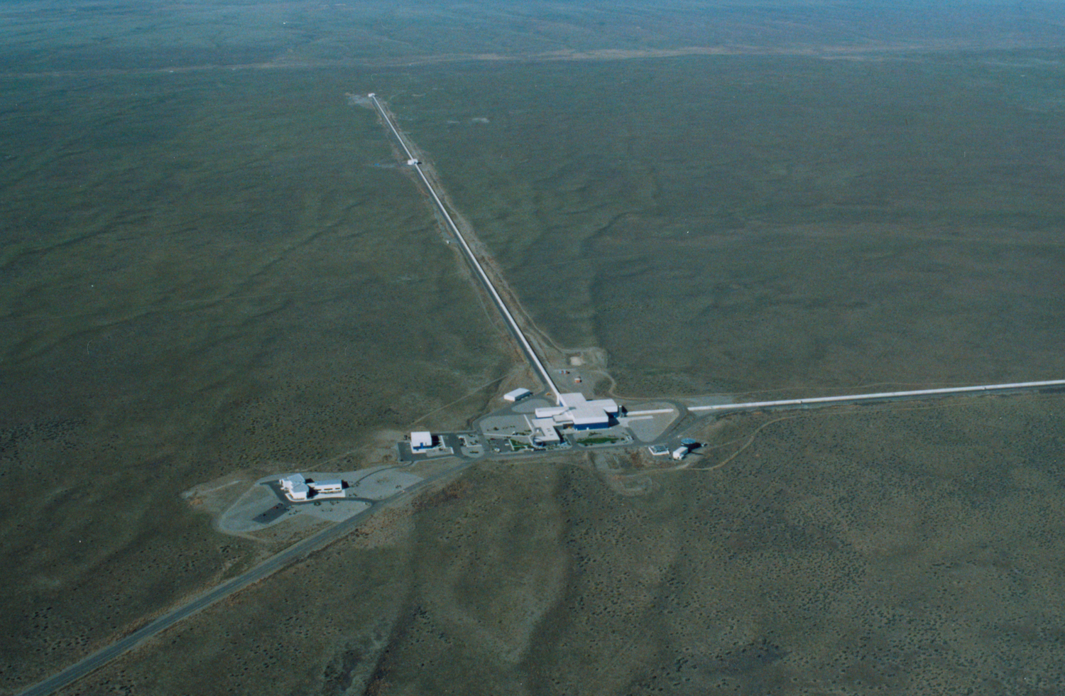 Aerial view of LIGO Hanford Observatory, showing the 4-kilometer interferometer arms stretching across the landscape
